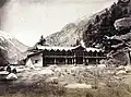 Wilson's bungalow in Harsil, c. 1860. Wilson is seated to the left with his brother-in-law Mungetu Chand