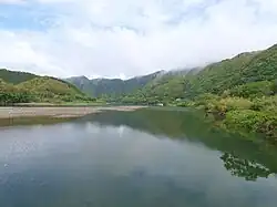 A wide river in a green mountain landscape.