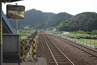 A view of the station platform and track, looking in the direction of Kannoura. Note the siding to the right is not connected to the main track. The large shed in the distance is the train depot.