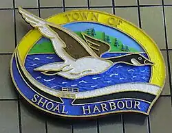 A wood carving of the town seal of Shoal Harbour on display at Memorial University of Newfoundland