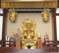 A Buddhist altar in Kawasaki, Japan showing a devotional mantra inscribed in Siddham to Shakyamuni Buddha with Japanese pronunciation guide