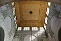 The wooden cupola ceiling and stucco-carved walls of the patio