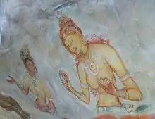 Painting on a rock face depicting two women, one dark-skinned and the other fair-skinned. Both are wearing jewellery and flowers, and both figures appear to be hidden in clouds below the waist.