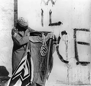 Sikh soldier with captured Swastika flag of Nazi Germany