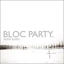 Mostly white album cover with winter image of grey tree line in distance, captioned "BLOC PARTY." and (much smaller) "SILENT ALARM" below it.