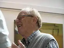 left profile (head and shoulders) of elderly man in animated discussion