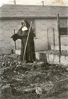 Sister Ann Joseph Morris working in chicken coop at Saint Mary-of-the-Fields.