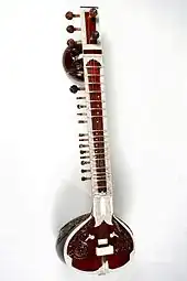 Sitar with resonator made from a bottle gourd. Surbahar is similar but larger and with lower sounds (something like a bass sitar)
