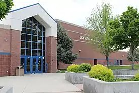 Photograph of the entry area to Skyview High School located on 1303 E Greenhurst Rd, Nampa, ID 83686 with a partial view of the school name sign.