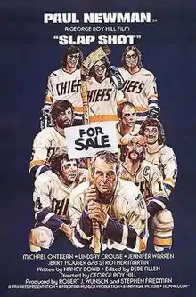 A group of hockey players, in the middle of the group one is holding a "For Sale" sign