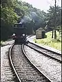 Steam engine running around its train.