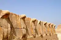 Frieze of sculpted uraei, or rearing cobras, atop a wall at the pyramid complex of Djoser. Twenty-eighth century BC.