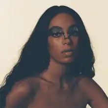 A photo of Knowles' face with a mask across her eyes