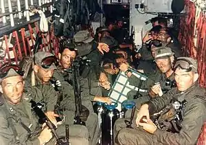 Blueboy assault group aboard HH-3E at the start of the mission. CPT Richard Meadows is seated in the left foreground.