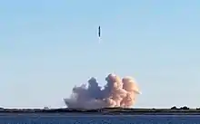 A picture of flying rocket, with large plume at the ground