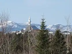 Church of Saint-Hilarion overlooking the village