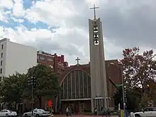 Photo of a Modernist Roman Catholic church on a cloudy day