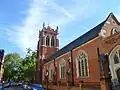 St Dionis, Parsons Green, London, 1884–85 by Ewan Christian, tower completed 1896, showing the north aisle and north-east tower, the church is in the Perpendicular Gothic style - less typical of Christian