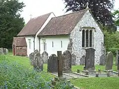 A simple small church with a red roof seen from the southeast