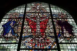 The large eastern Christ in Majesty Window, designed by Lawrence Lee, Royal College of Art, in the Chancel, depicting Mary, mother of Jesus, Jesus, Paul the Apostle, a dove symbolising the Holy Spirit and an eye symbolising God the Father, 1967.