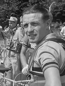 A male cyclist looking over his shoulder