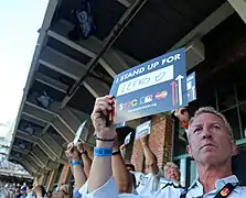 Fans pay tribute by standing with signs at the 2016 Major League Baseball All-Star Game