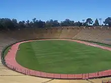 A view of Stanford Stadium from the stands, showing the pitch encircled by a running track