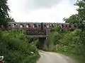 Train crossing the bridge over the lane