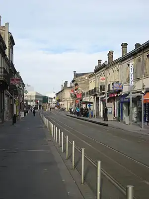 Double-track railway line in the street with side platform