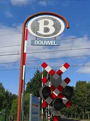 Station Bouwel with NMBS/SNCB logo with level crossing signaling