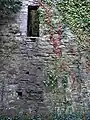 north wall of the church; postholes where wooden steps allowed access to the tower are visible.