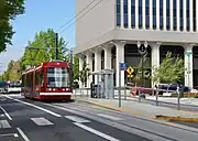 The Portland Streetcar platform at Northeast 7th & Holladay with a streetcar stopped next to it.