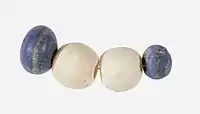 String of beads; 3650–3100 BC; lapis lazuli (the blue beads) and travertine (the white beads) (Egyptian alabaster); length: 4.5 cm; by Naqada II or Naqada III cultures; Metropolitan Museum of Art (New York City)