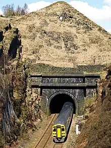 A train emerging from a tunnel portal