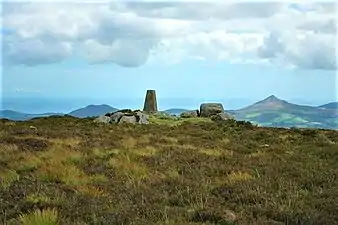 Summit triangulation pillar. In the distance is the Great Sugar Loaf (right), and Little Sugar Loaf (left)