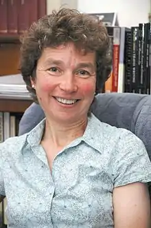 colour portrait photograph of Susan Manning in her office in IASH, University of Edinburgh