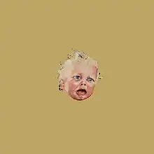 an unhappy baby’s face in the middle of a plain brown background