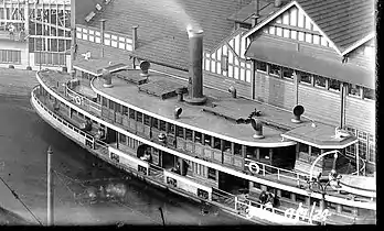 Kameruka in her original varnished timber and white trim livery, Circular Quay pre early 1930s. Prior to her first re-built with her original rounded (not squared) roof life returns to wheelhouse