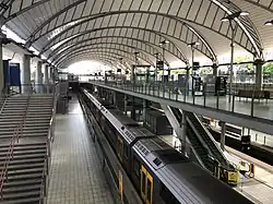 Olympic Park station in Sydney. All passengers alight on the middle island platform and board from the significantly wider outer platforms.