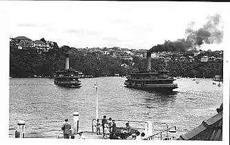 Kubu (left) approaches the wharf as Kanangra leaves, 1950s