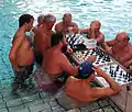 Men playing chess in the baths.