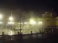 Steam rising from the baths at night.