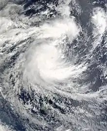 Satellite image of a strengthening tropical cyclone. It developed a ragged central dense overcast, with some area of thunderstorms and clouds.