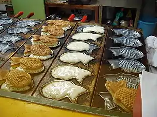 Taiyaki cakes being made in the shape of red seabream (tai)