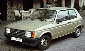 A small three-door passenger car.