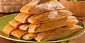 Tamales wrapped in corn husks.