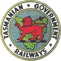 Logo of the Tasmanian Government Railways, showing the Tasmanian Red Lion on a Map of Tasmania, surrounded by Tasmanian Government Railways text.