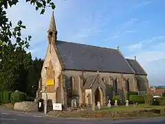 Stone building with arched windows and small turret.