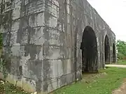 A gate built of massive grey stones.
