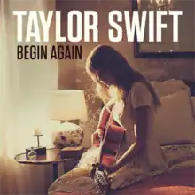 Cover artwork of "Begin Again", showing Taylor Swift strumming a guitar while sitting by a window